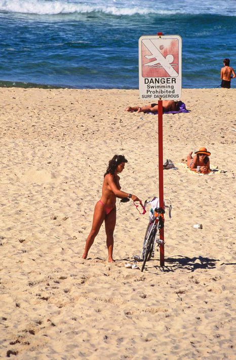 Girl at Beach near Sign, Australia