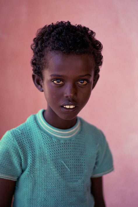 Young Boy in Green Against Pinkish Wall, Somalia