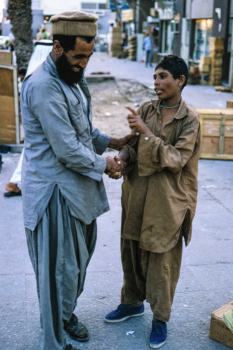 Boy with Man Shaking Hands, Abu Dhabi