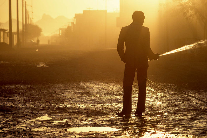 Silhouetted Man with Hose, Water, Iran