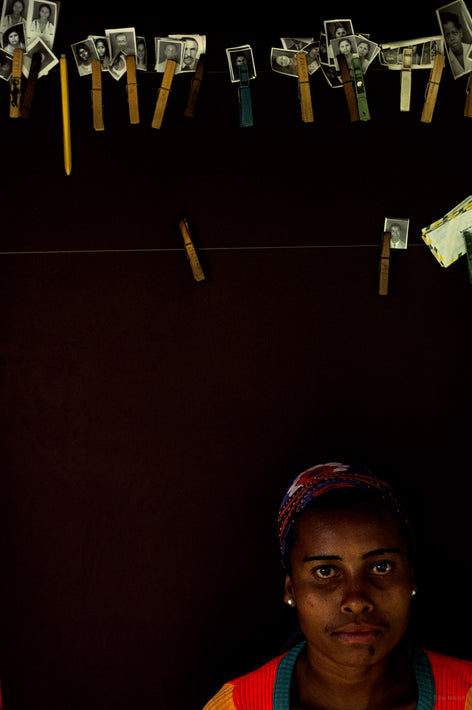 Woman Against Black with Pictures on Clothespins, Bahia