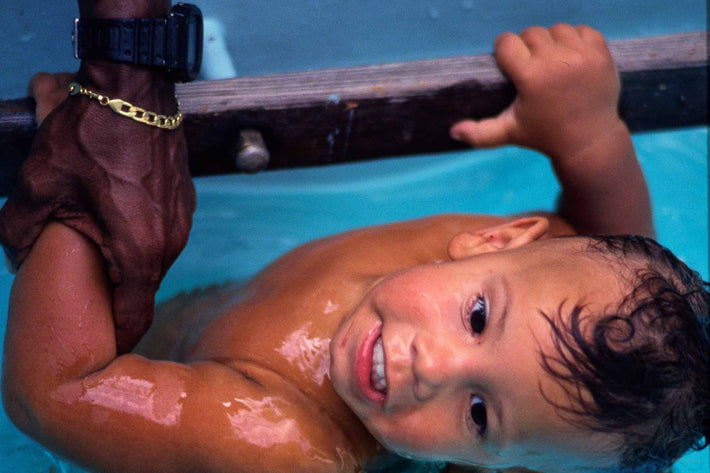 Child in Pool with Hand Holding Him, Rio de Janeiro