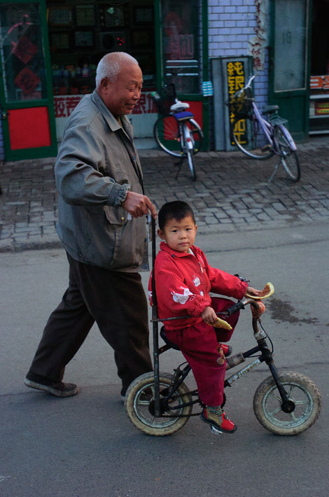 Man Wheeling Kid on Bike, Pingyao