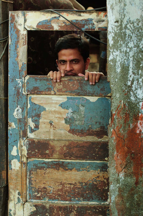 Man Looking Through Top Section of Door, Mumbai