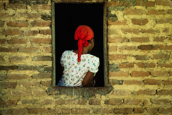 Brick Wall, Woman's Back in Window