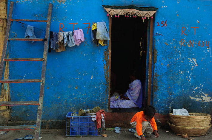 Kid in Orange Against Blue Wall, Mumbai