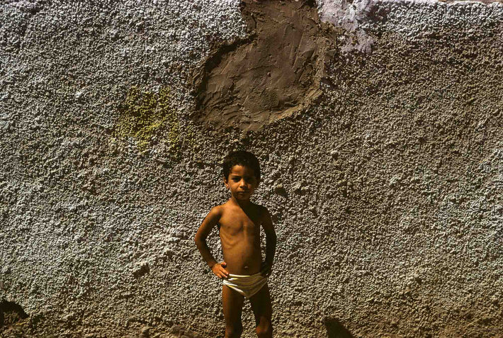 Child, Hands on Hips Against Textured Wall, Marrakech