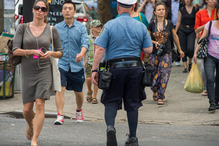 Woman in Grey, Cop in Shorts, NYC