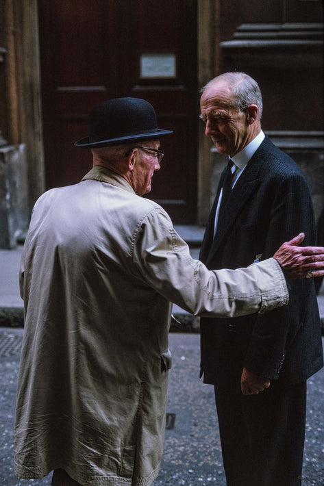 Two Men, One Holding the Others Elbow, London