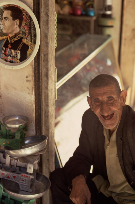 Old Man Laughing with Portrait of Shah in Background, Iran