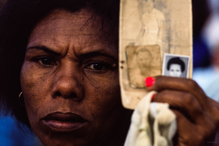 Woman Close-up Holding Up Photos for Faith Healer, Bahia