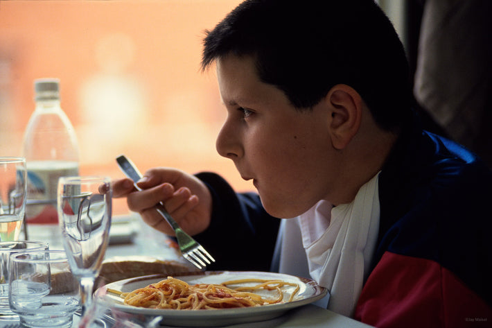 Kid Eating Pasta on Train, Unknown Locale, Italy