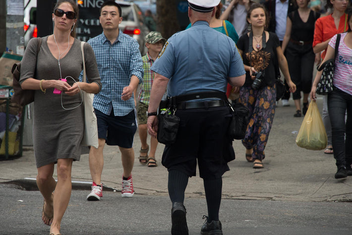 Woman Walking, Back of Cop, NYC