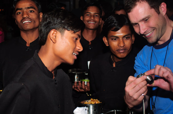 Man in Blue Showing Picture to Four in Back, Mumbai