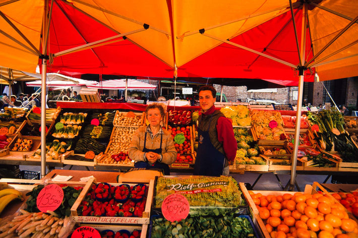 Mother and Son at Market Fruit Stand