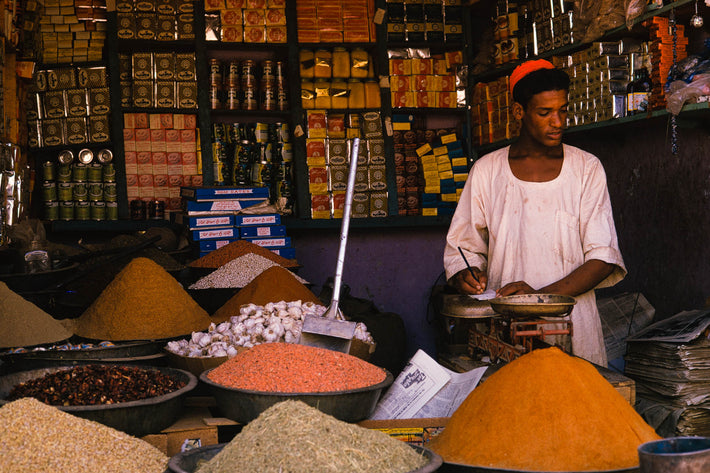 Man in Market with Piles of Grains and Spices, Khartoum