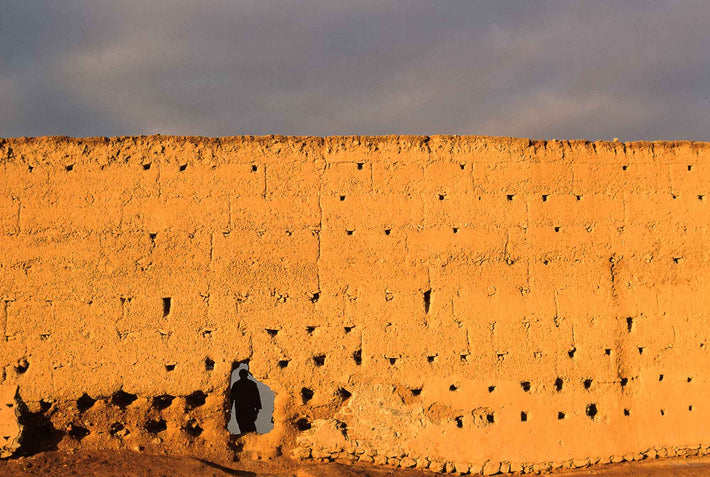 Man Walking Through Hole in Wall, Marrakech
