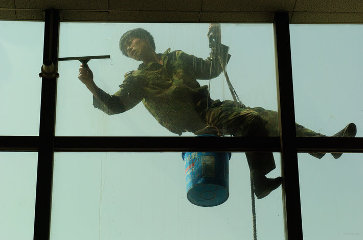 Man Cleaning Window at Airport, Beijing