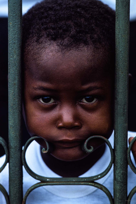 Child's Face Through Green Fence, Bahia
