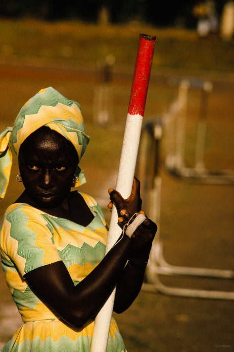 Woman Holding Red and White Pipe, Ghana