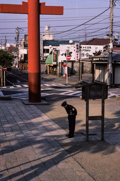 Policeman Bowing (To No One) in Street, Kamakura