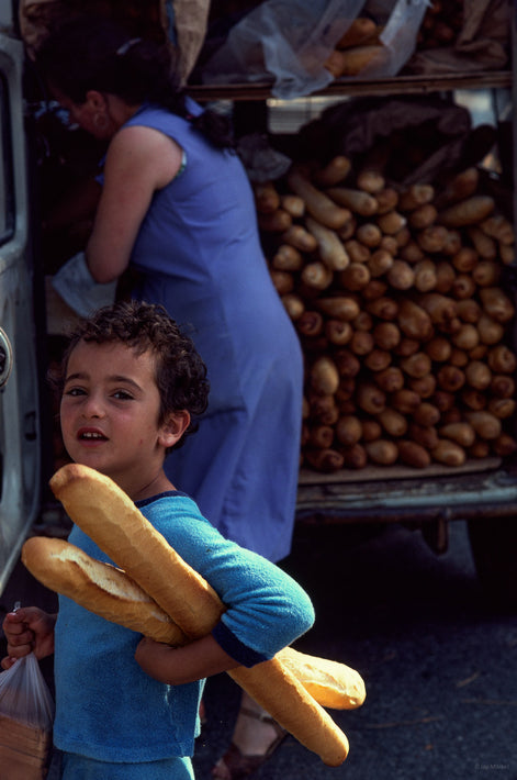 Boy with Two Baguettes, Truck in Background, France
