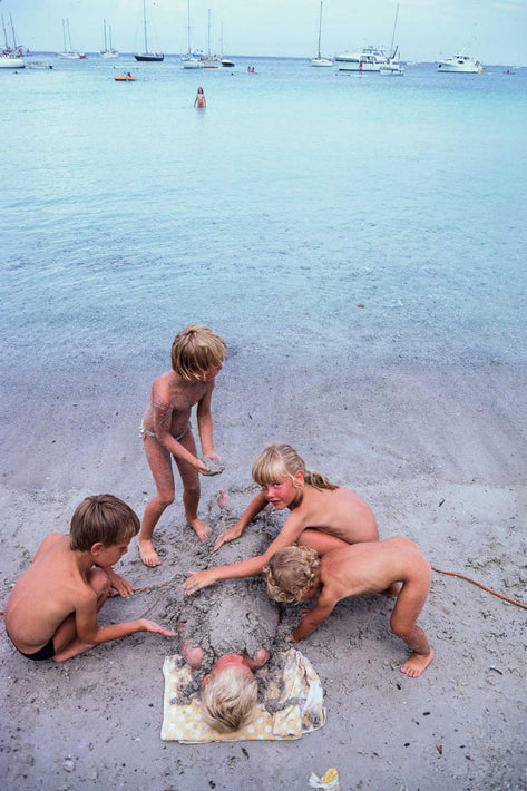 Four Kids Burying One Kid in Mud