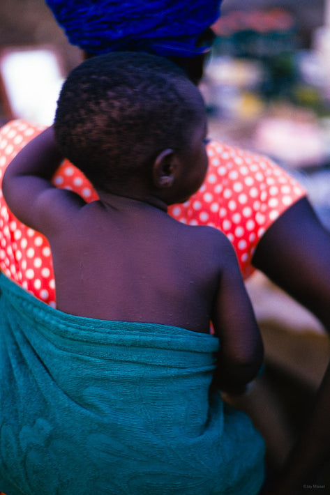 Woman in Polka Dot Dress with Child Carried in Green Towel, Liberia