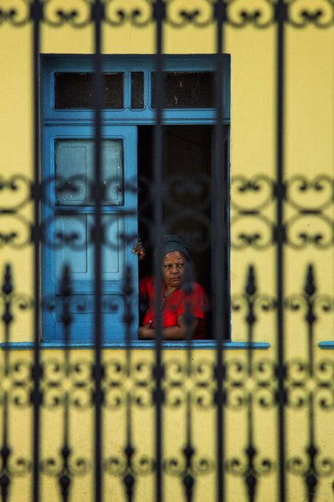 Woman in Red, Yellow Wall, Fence in Foreground, Bahia