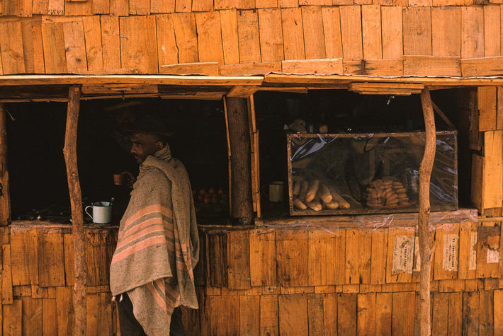 Man in Serape with Coffee Cup, Antananarivo