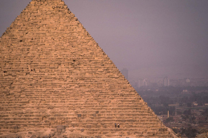 Pyramid with Two Kids, City in Background, Egypt