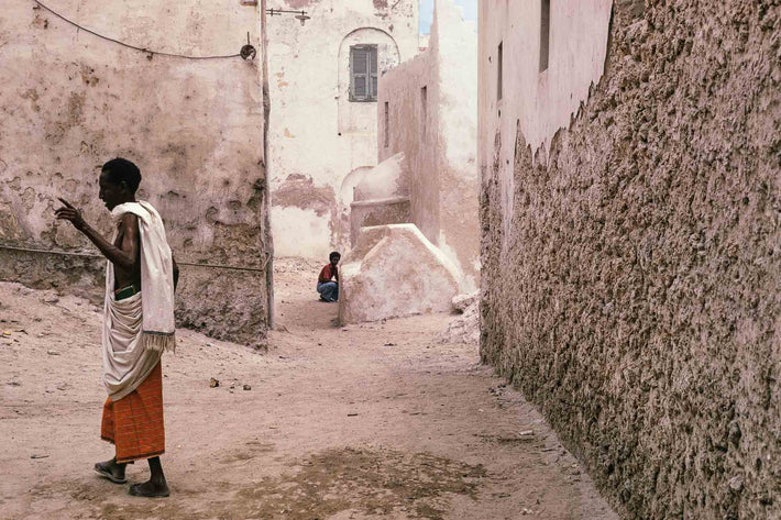 Back Alley, One Man Crouching, One Gesturing