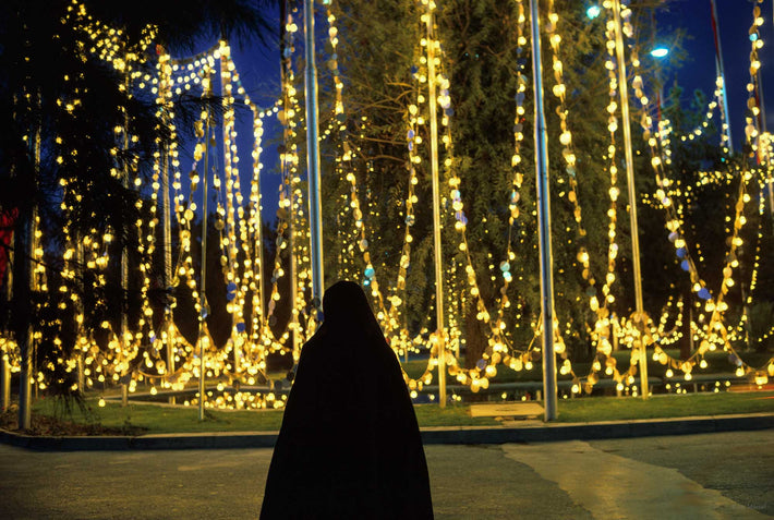 Woman in Chador Against Yellow Lights, Iran