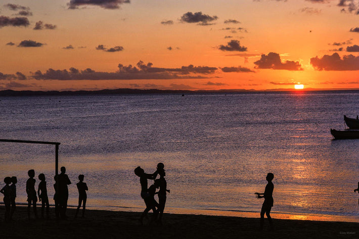 Boys Silhouetted Against Blue Water, Sun Setting, Bahia