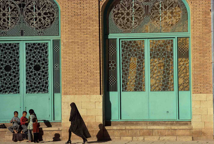 Children and Woman Against Wall with Ornamental Iron Work, Iran