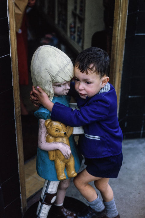 Boy Holding Wooden Figure of Girl, London
