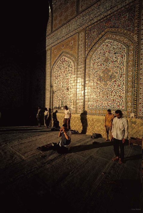 Men in Prayer with Sunlit Tiled Wall in Background, Iran