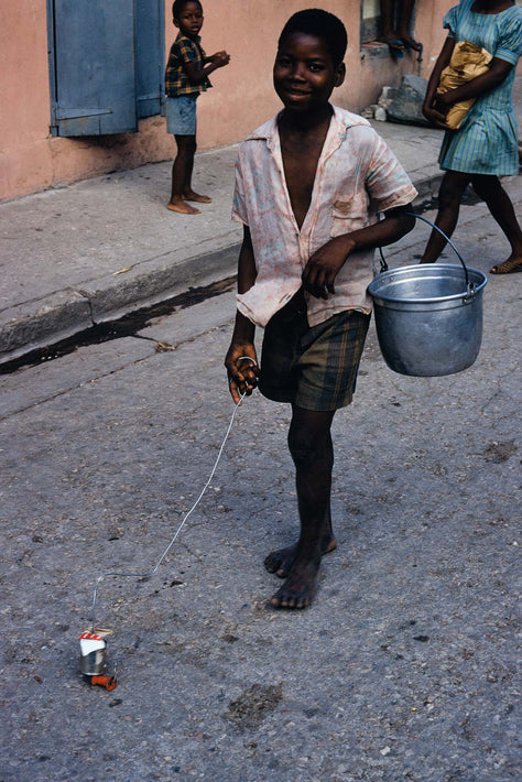 Boy with Toy and Bucket, Haiti